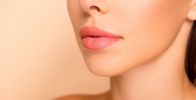 Profile view of woman with sculpted cheekbones from contouring with self-tanner