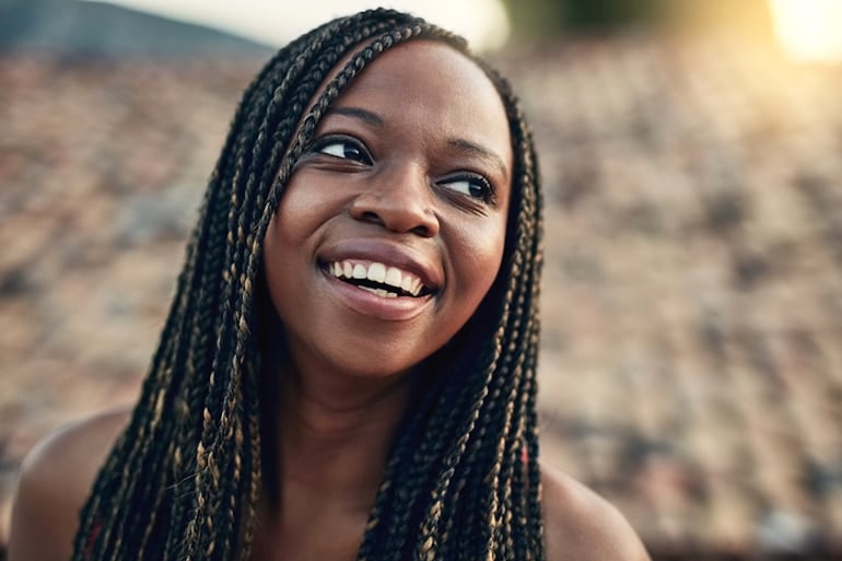 Woman outdoors with beautiful skin after taking the best vitamins to make skin glow