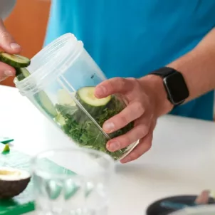 Active man making a green smoothie as an easy way to detox the body daily and naturally