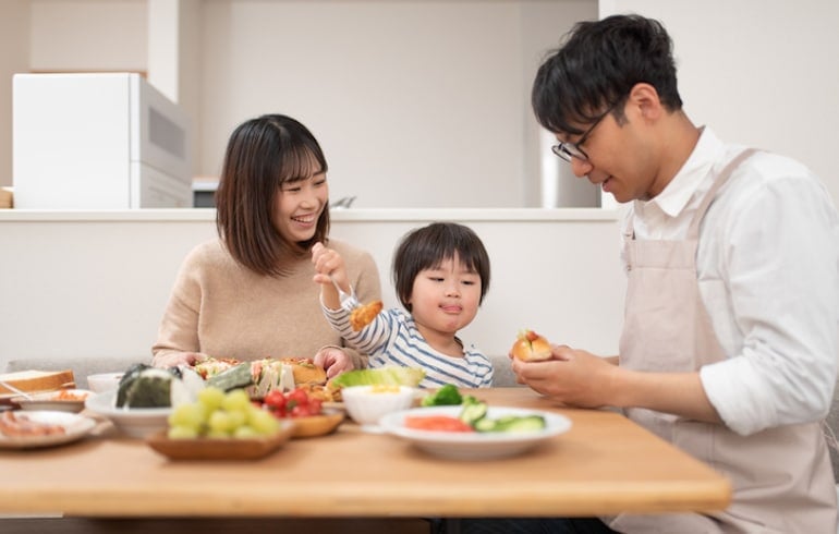 Asian family eating lunch at home that's unique to their ancestry and bio-individuality