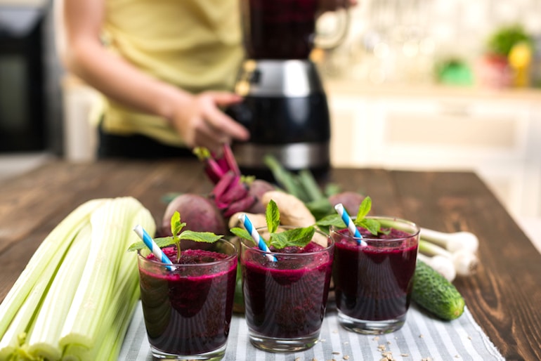 Woman making beet juice, one of the top brain healthy foods that increases blood flow to the brain