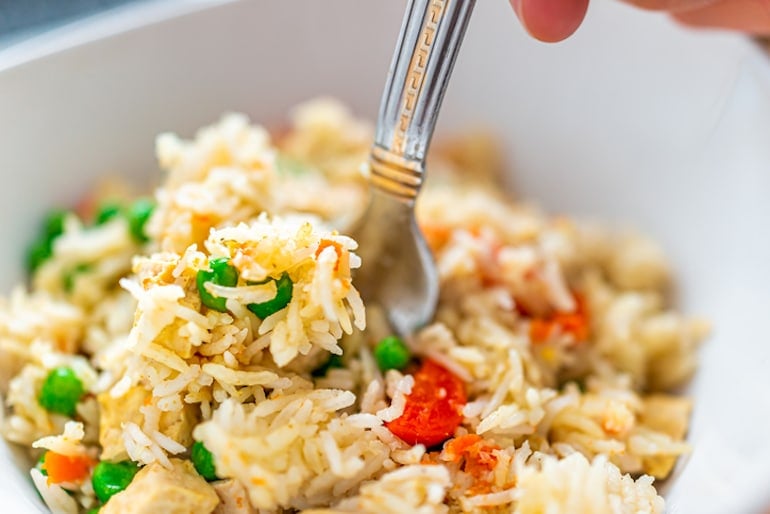 Digging into a balanced meal with rice for complex carbs, and veggies for color