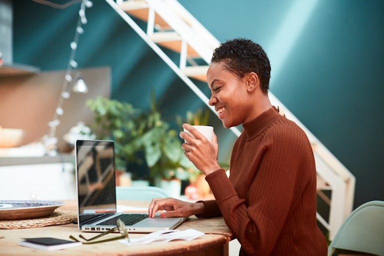 Woman working at home office, happy to finally achieve inbox zero