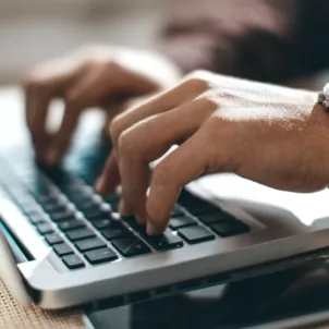 Man's hands at work on laptop, implementing the inbox zero method