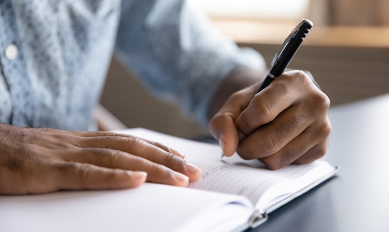 Man journaling to discover his true needs and desires before embarking on a minimalist lifestyle