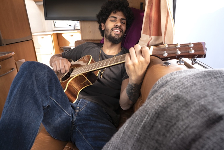 Man playing guitar, a fun way to exercise your brain