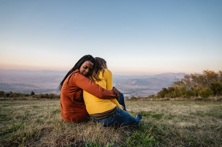 Woman reassuring stressed friend