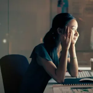 Woman staring at computer late at night, illustrating how the internet is changing your brain