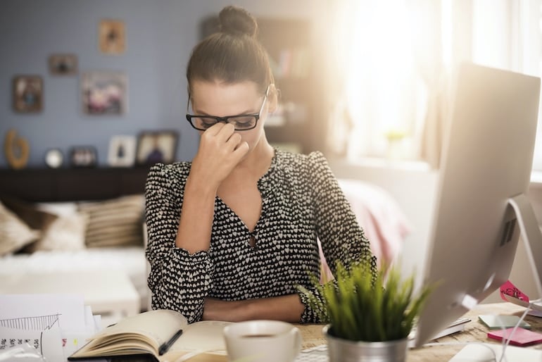 Woman stressed from her crowded inbox, in need to implement the inbox zero method for less stress and more productivity