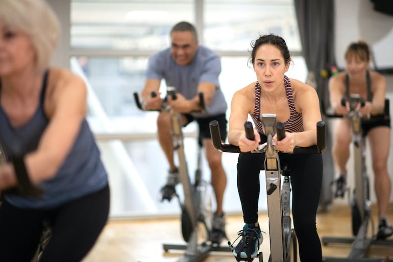 Group spinning class to illustrate cardio exercise concept for weight loss