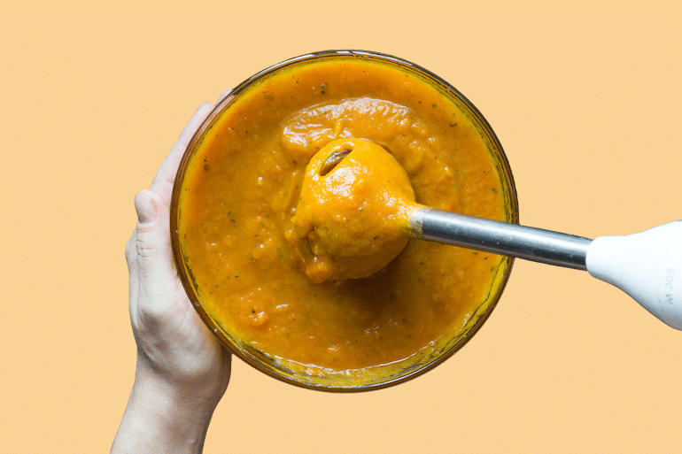 Person blending pumpkin puree to get the nutritional benefits of pumpkin