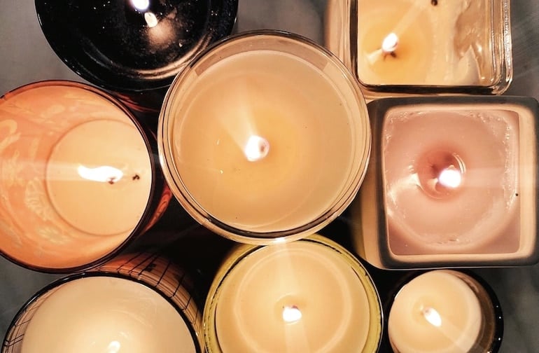 Collection of lit candles, a great addition to a self-care routine