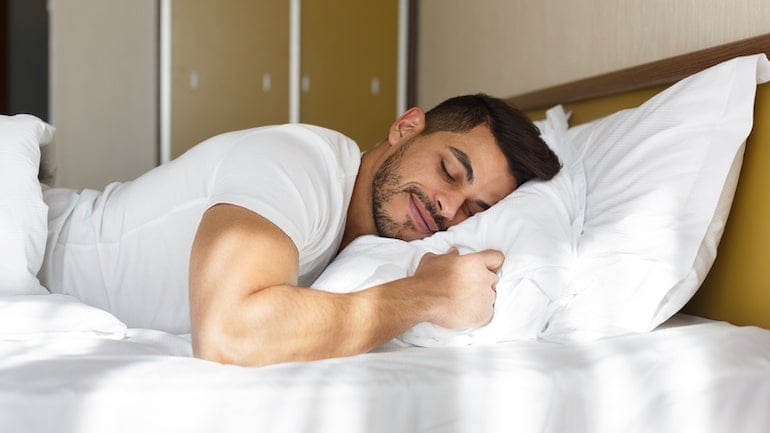 Man sleeping on his stomach to illustrate Different types of sleeping positions and their meanings