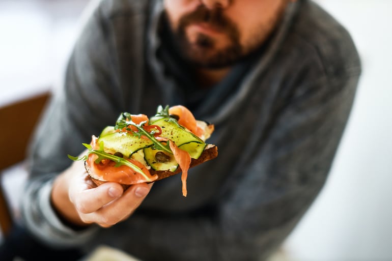 Man eating salmon bruschetta to boost sperm healthy and support male fertility