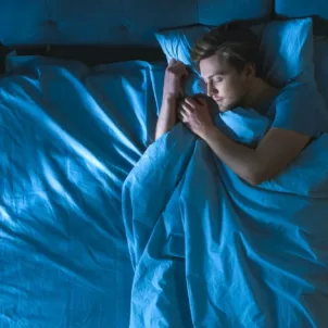 Man sleeping with his mouth closed for oral health benefits