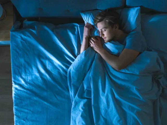 Man sleeping with his mouth closed for oral health benefits