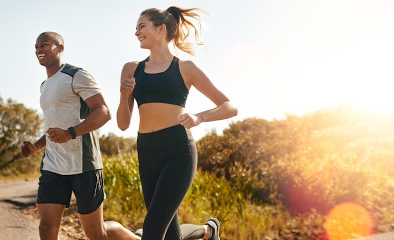 Man and woman jogging to stay fit and boost immunity naturally