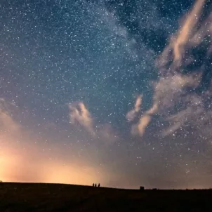 Bright night sky with blue and orange tones in a field; horoscope and astrology concept