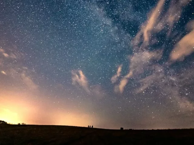 Bright night sky with blue and orange tones in a field; horoscope and astrology concept