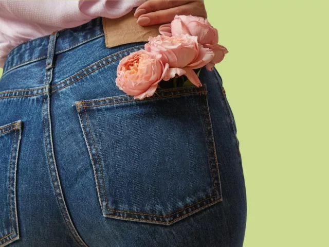Woman's butt with a flower in her pocket to illustrate why we fart and why farts smell