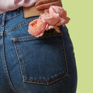 Woman's butt with a flower in her pocket to illustrate why we fart and why farts smell