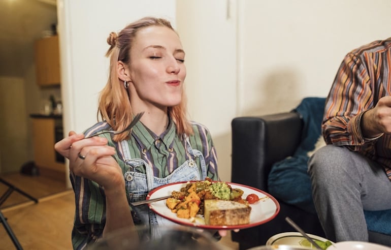 Woman chewing her food slowly and practicing mindful eating