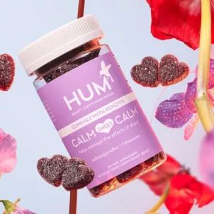 HUM Calm Sweet Calm stress gummies with flowers in front of a lilac background