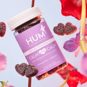 HUM Calm Sweet Calm stress gummies with flowers in front of a lilac background