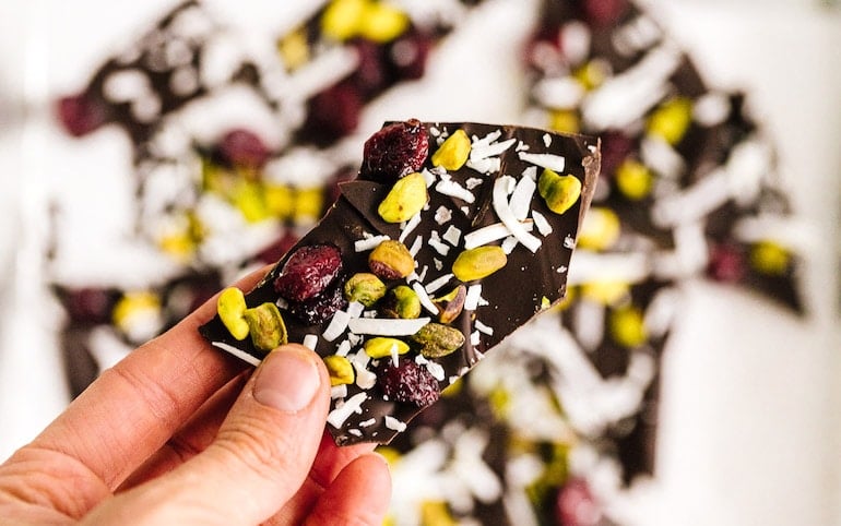 Cranberry Pistachio Dark Chocolate Bark in hand