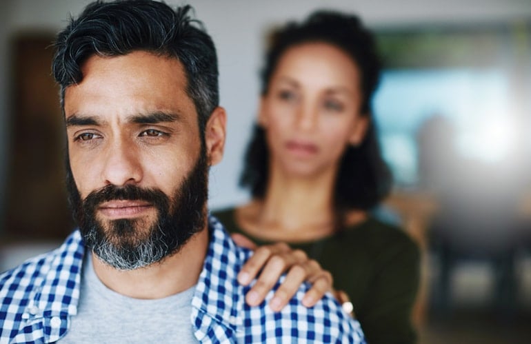 Woman comforting distraught husband over erectile dysfunction from as a hormone imbalance symptom