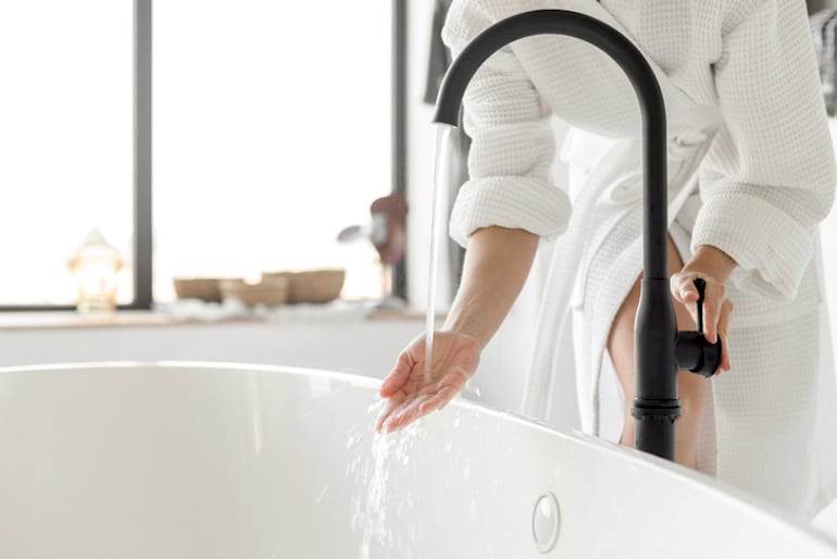 Woman running a bath; concept of what healthy and normal vaginal discharge looks like