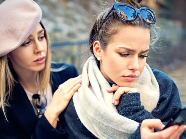 Two girls upset outside to demonstrate the major reasons to end a friendship and how to end a friendship with care