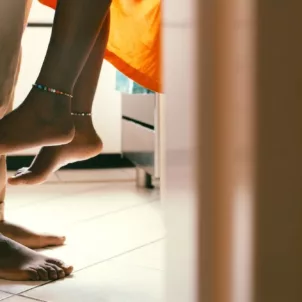 Low shot of sexy couple in kitchen to illustrate the concept of libido-boosting foods to spice up your sex life