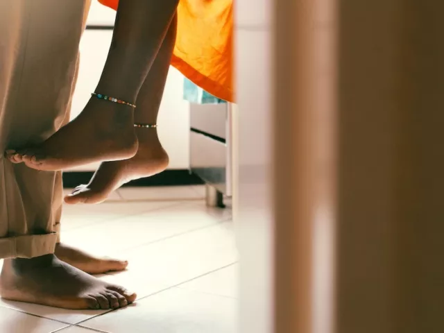 Low shot of sexy couple in kitchen to illustrate the concept of libido-boosting foods to spice up your sex life