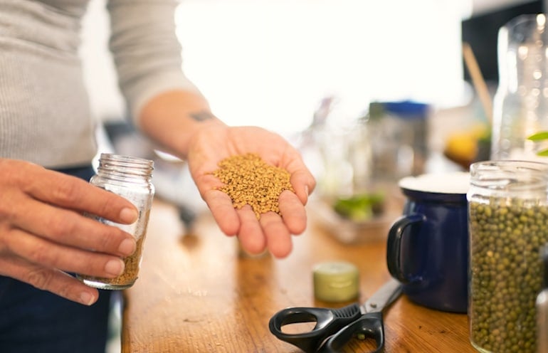 Woman holding fenugreek seeds to add to her diet for its libido-boosting effects