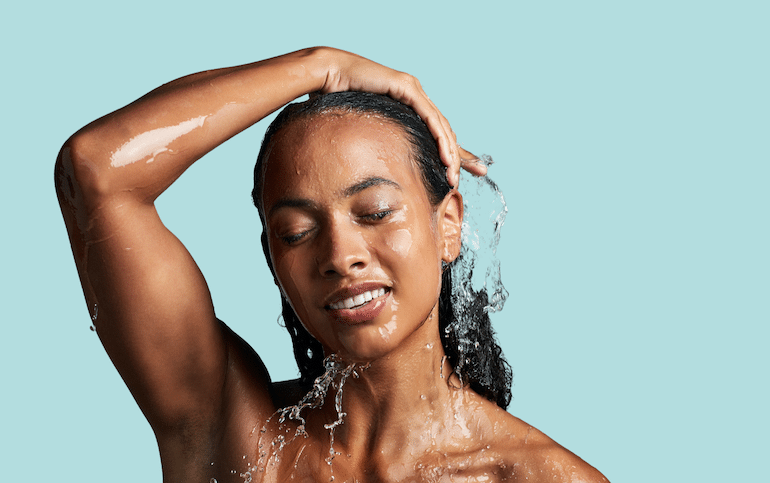 Woman washing her natural curly hair