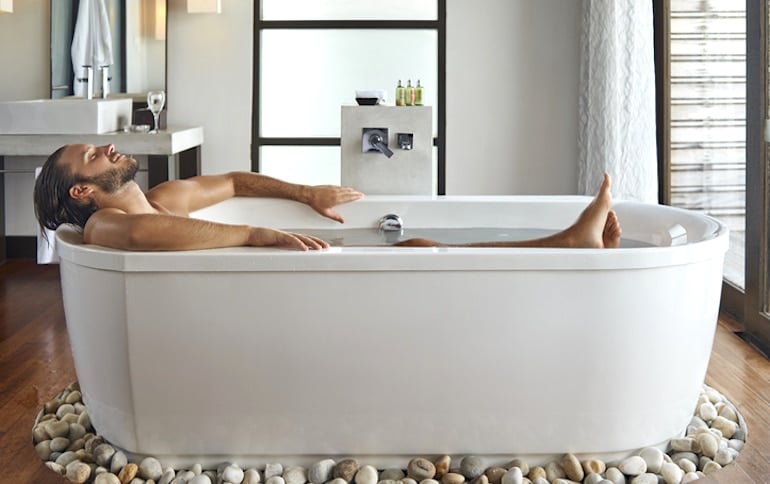 man taking a bath to relax and disconnect from stressors