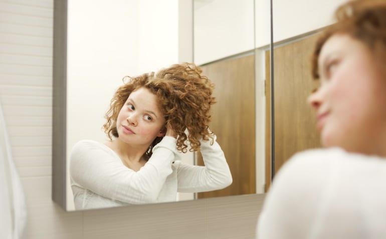 Woman styling her natural curls