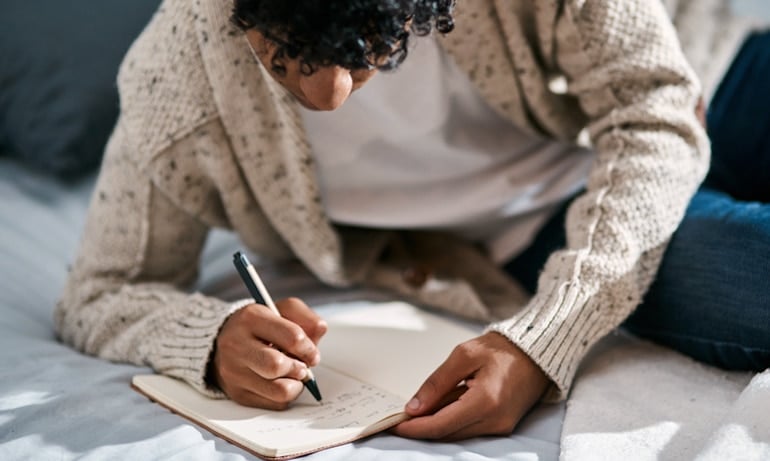 man journaling as a science-backed stress reduction technique