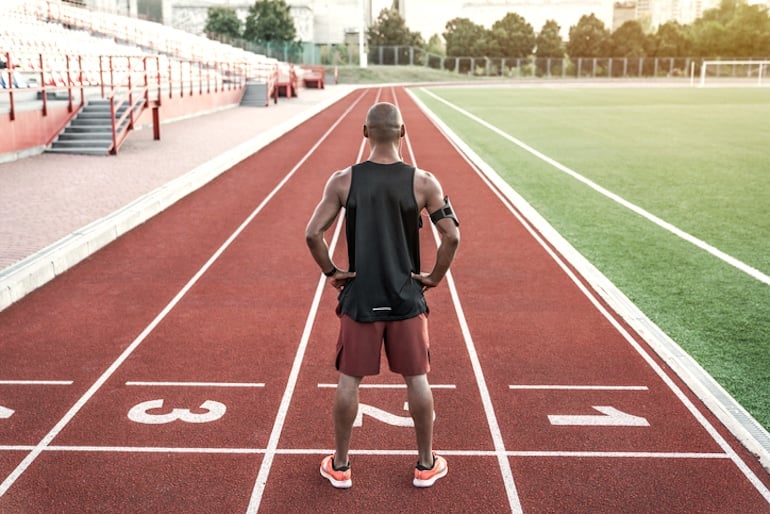 Man on racetrack healthily handling the challenge of positive stress