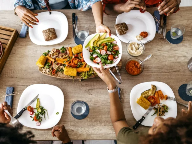 Overhead shot of Black nutrition experts sitting down for a healthy meal