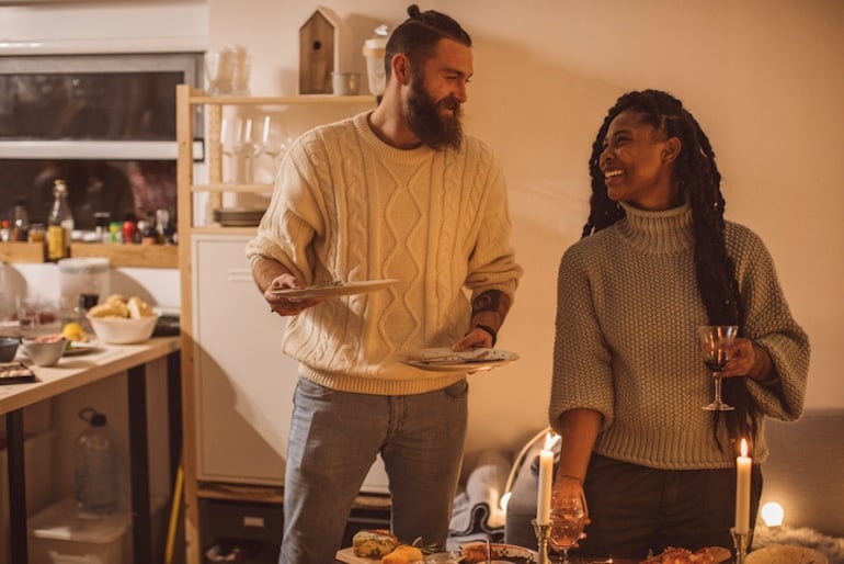 Couple clearing the table after having a late dinner