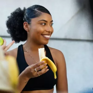 Woman eating a banana as a post workout food