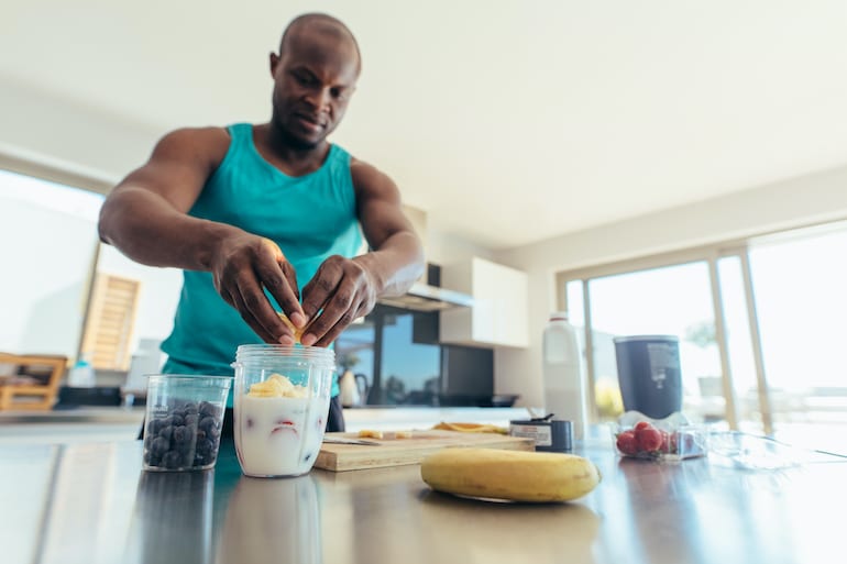 Man preparing smoothie as muscle repair food