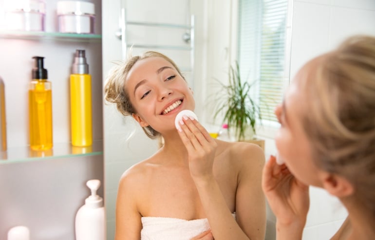 Woman applying niacinamide toner for hydrated, glowing skin