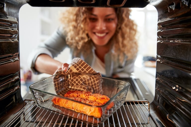 Woman eating salmon as a detoxification food