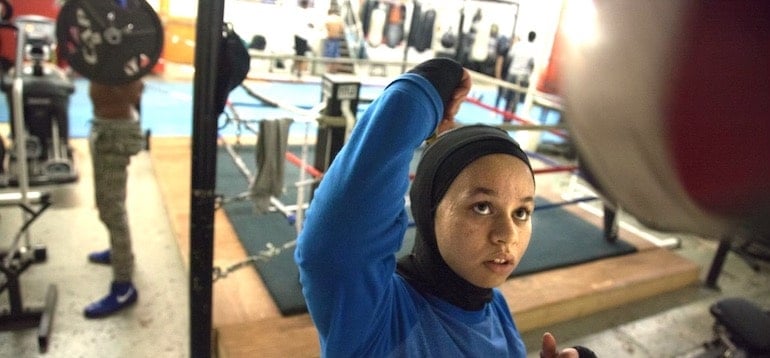 Boxer Amaiya Zafar punching a bag at boxing gym, powered by healthy eats from her daily food diary