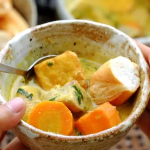 Woman eating vegan curry for dinner