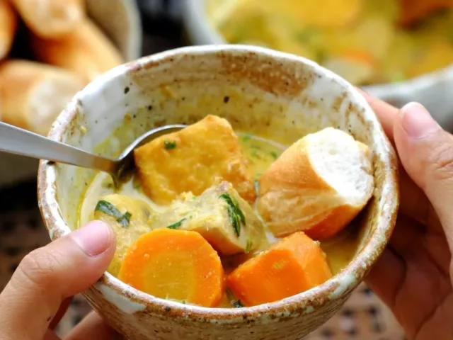 Woman eating vegan curry for dinner