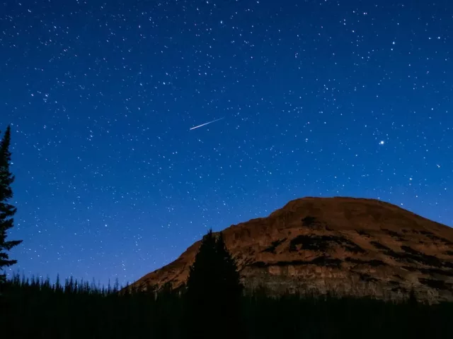 Starry night sky in a mountain desert landscape; astrology and wellness horoscopes concept